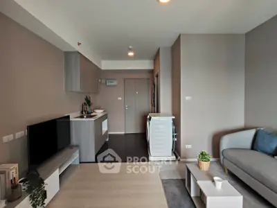 Modern living room with sleek furniture and compact kitchen in open layout