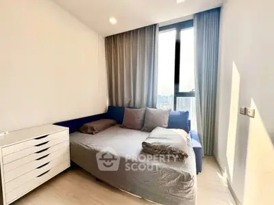 Modern bedroom with city view, featuring a cozy bed and stylish decor.