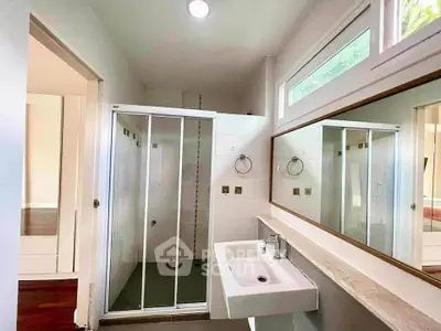 Modern bathroom with sleek shower and large mirror