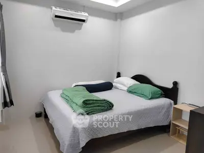 Cozy bedroom with air conditioning and minimalist decor, perfect for restful nights.