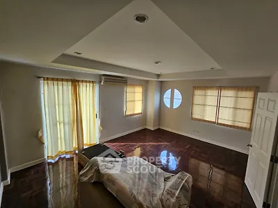 Spacious living room with hardwood floors and natural light