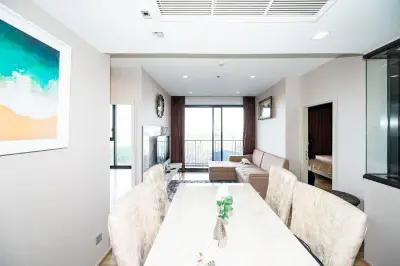 Spacious modern living room with elegant dining area and large windows for natural light.