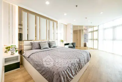 Luxurious bedroom with elegant decor and ample natural light