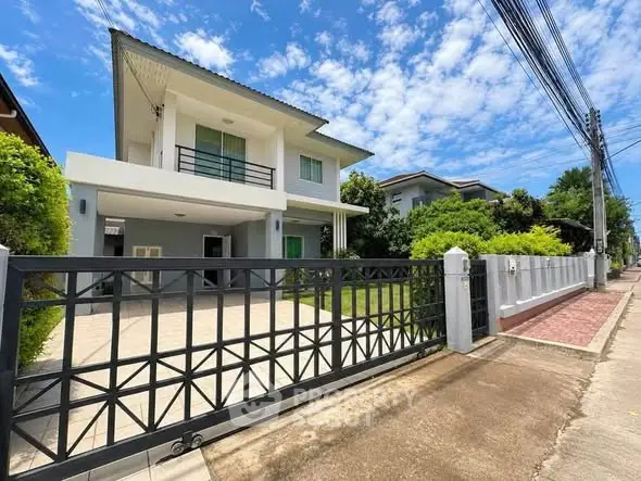 Stunning modern two-story house with spacious driveway and lush greenery, perfect for family living.