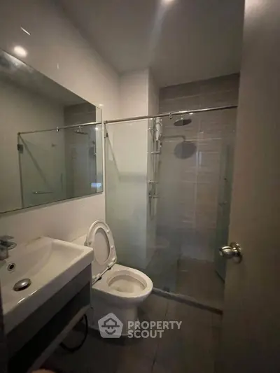 Modern bathroom with glass shower and sleek fixtures