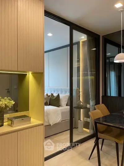 Modern apartment interior with stylish bedroom and dining area, featuring elegant decor and warm lighting.