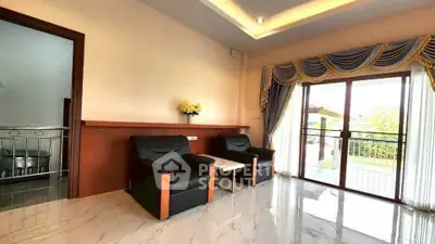 Spacious living room with elegant drapes and garden view, featuring modern seating and glossy flooring.
