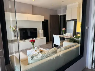 Modern living room with sleek furniture and open kitchen layout