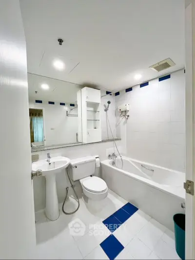 Modern bathroom with white tiles and bathtub in a stylish apartment