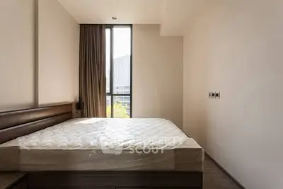 Spacious bedroom with large window and modern design