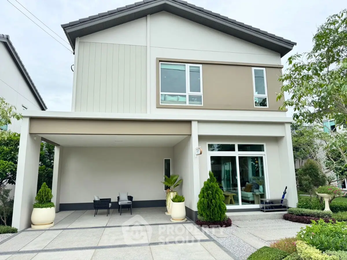 Modern two-story house with spacious driveway and lush greenery.