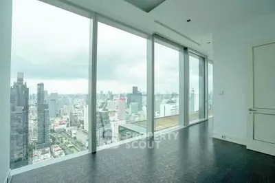 Stunning high-rise apartment with floor-to-ceiling windows offering panoramic city views.