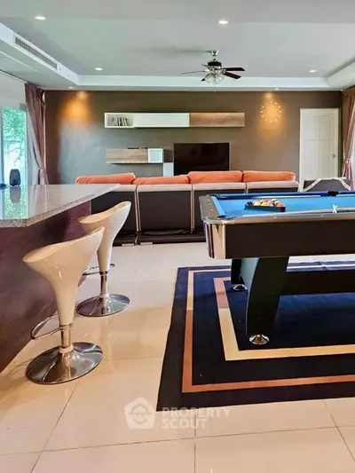 Luxurious living room with pool table and modern decor