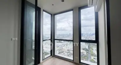 Stunning corner unit with panoramic city views from floor-to-ceiling windows.