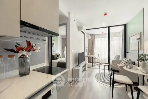 Modern open-plan living room and kitchen with stylish decor and natural light.