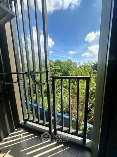 Charming balcony with lush green view and modern railing design, perfect for relaxation and enjoying nature.