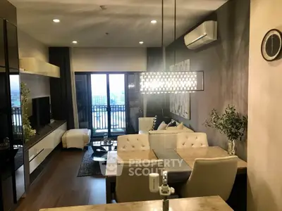 Modern living room with elegant decor and balcony view in a stylish apartment.