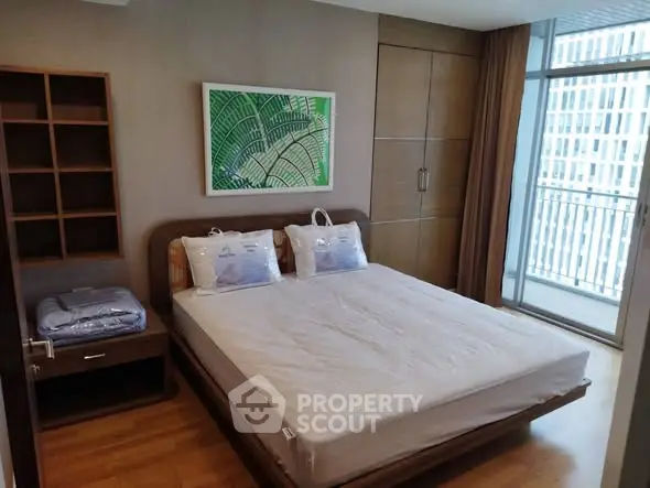 Modern bedroom with balcony view in high-rise apartment