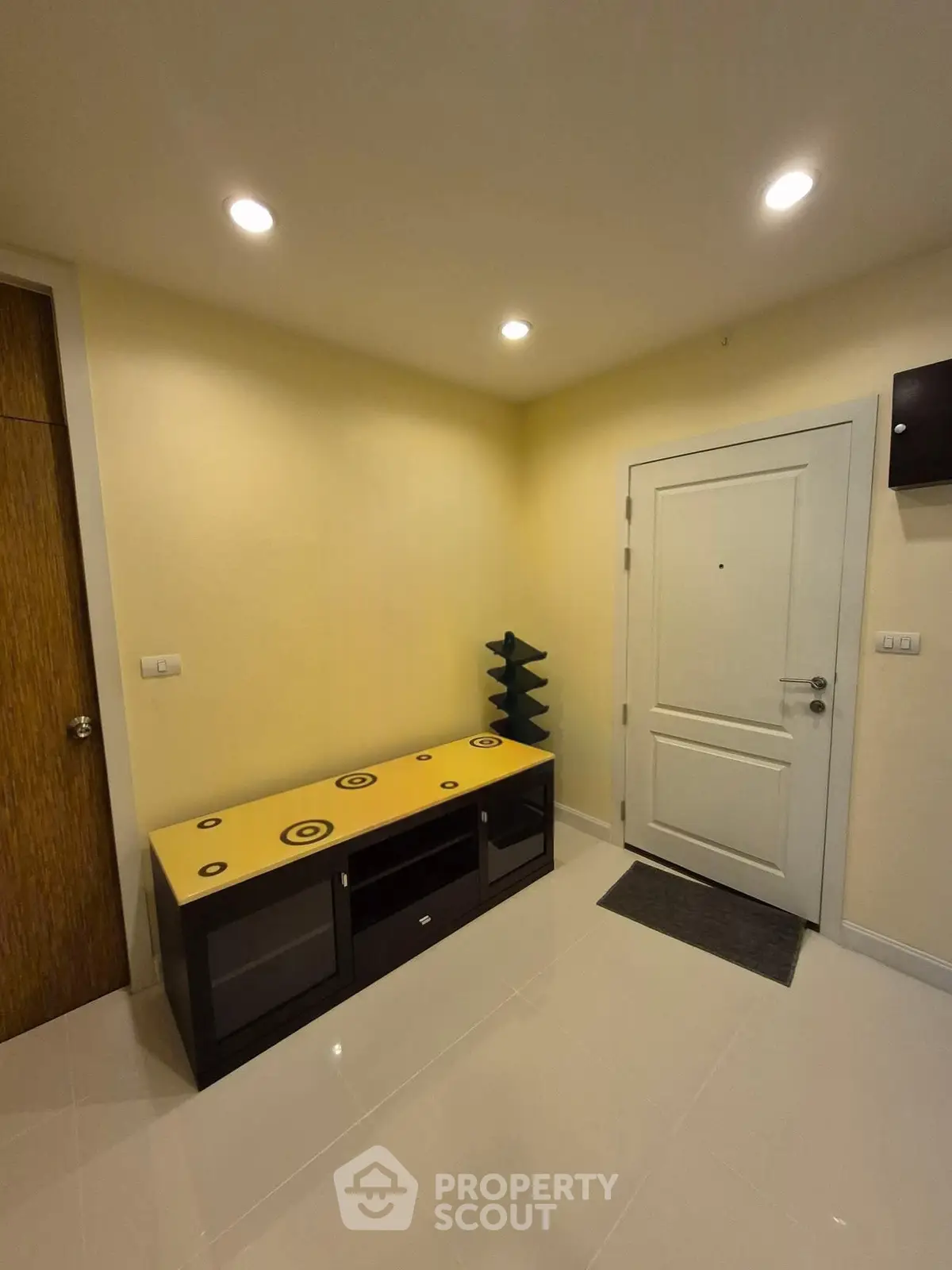 Modern entryway with sleek storage and bright lighting