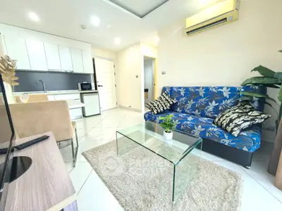 Modern living room with stylish sofa and open kitchen layout
