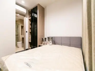 Modern bedroom with ensuite bathroom and sleek storage solutions