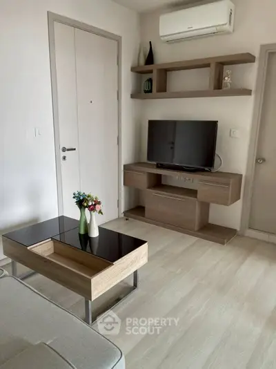 Modern living room with sleek furniture and wall-mounted TV, perfect for contemporary lifestyle.