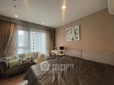 Modern bedroom with city view, stylish decor, and cozy seating area.