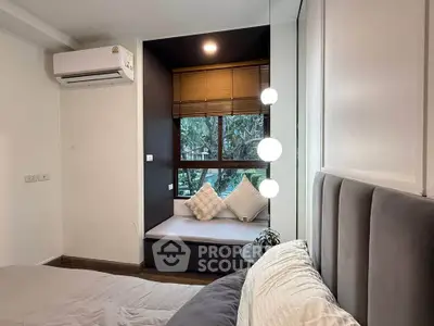 Cozy bedroom with window seat and modern lighting in a stylish apartment.