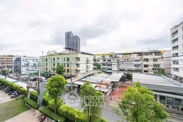 Urban cityscape view with residential buildings and greenery, showcasing vibrant neighborhood living.