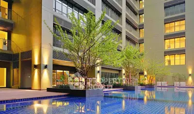 Luxurious apartment building with stunning pool and modern architecture.