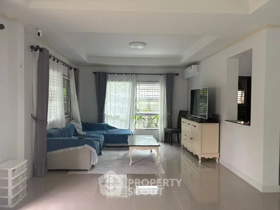 Spacious living room with modern decor and natural light