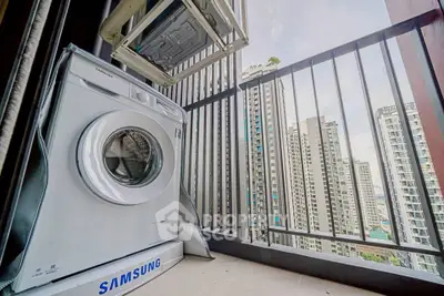 Modern balcony with washing machine and city skyline view