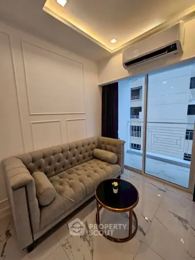Elegant living room with modern sofa and air conditioning, featuring sleek marble flooring and balcony access.