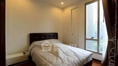 Cozy bedroom with large window and city view