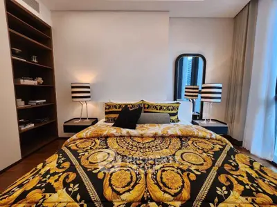 Luxurious bedroom with elegant decor and stylish lighting, featuring a plush bed and modern furnishings.
