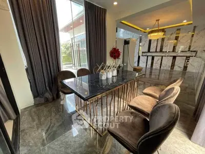 Luxurious dining area with elegant marble table and plush chairs in modern home