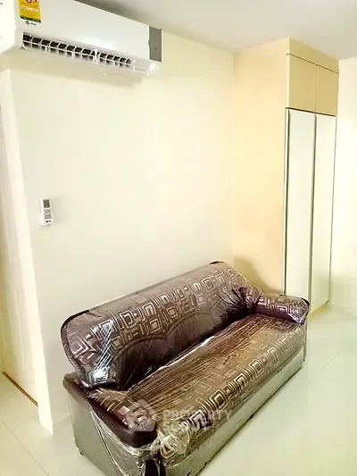 Cozy living room with modern sofa and air conditioning in a stylish apartment.