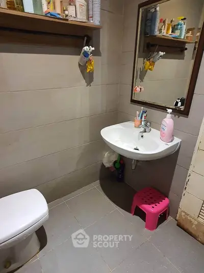 Cozy bathroom with modern sink and wall-mounted mirror, ideal for compact spaces.