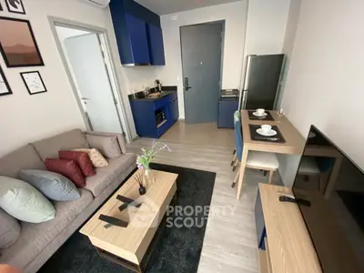 Modern living room with compact kitchen and stylish decor