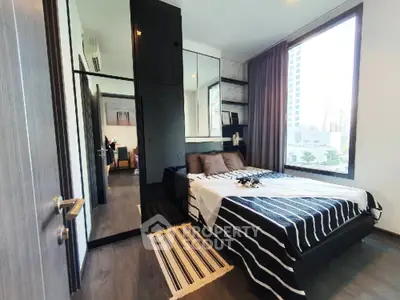 Modern bedroom with large window and stylish decor in urban apartment