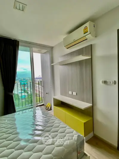 Modern bedroom with balcony view and air conditioning in urban apartment
