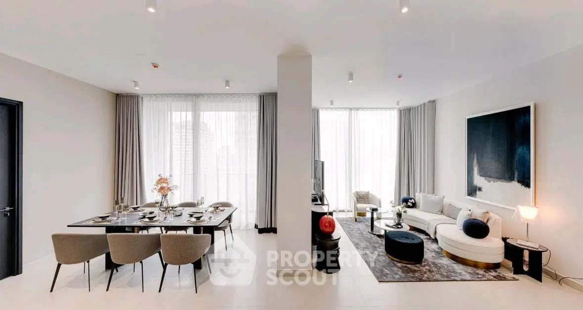 Spacious modern living and dining area with elegant decor and large windows.