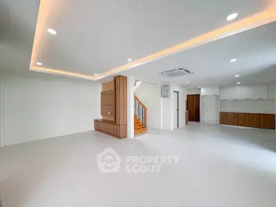 Spacious modern living room with recessed lighting and open layout