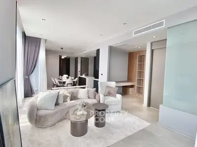 Luxurious modern living room with elegant furniture and open dining area