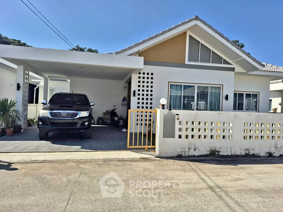 Charming single-story house with carport and modern facade in a serene neighborhood.