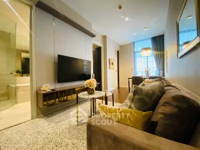 Luxurious modern living room with elegant decor and large TV, perfect for relaxation and entertainment.