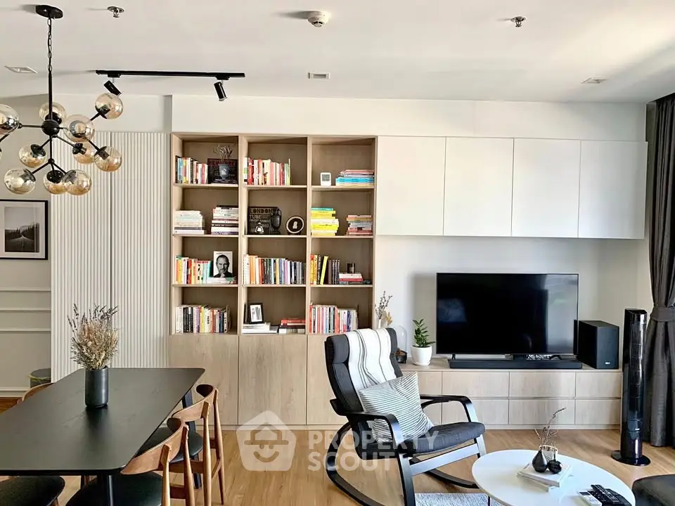 Modern living room with stylish furniture and built-in bookshelf