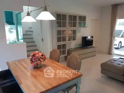 Charming open-plan living and dining area with stylish furniture and natural light.