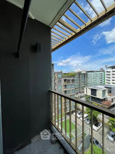 Charming balcony with city view in modern apartment building, perfect for relaxation and enjoying the skyline.