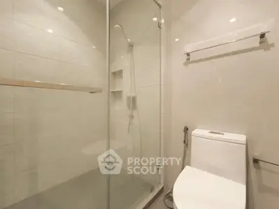 Modern bathroom with glass shower and sleek toilet design
